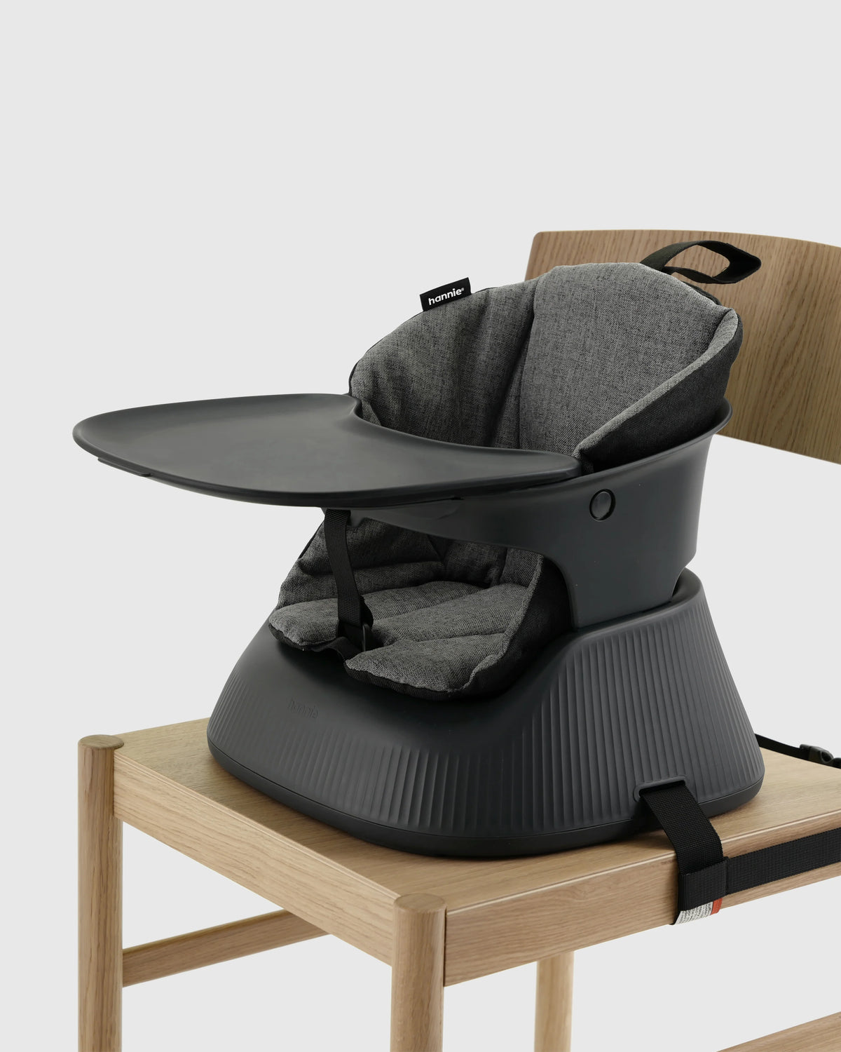 Hannie portable high chair in charcoal black, shown from a black perspective with various angles and parts visible.