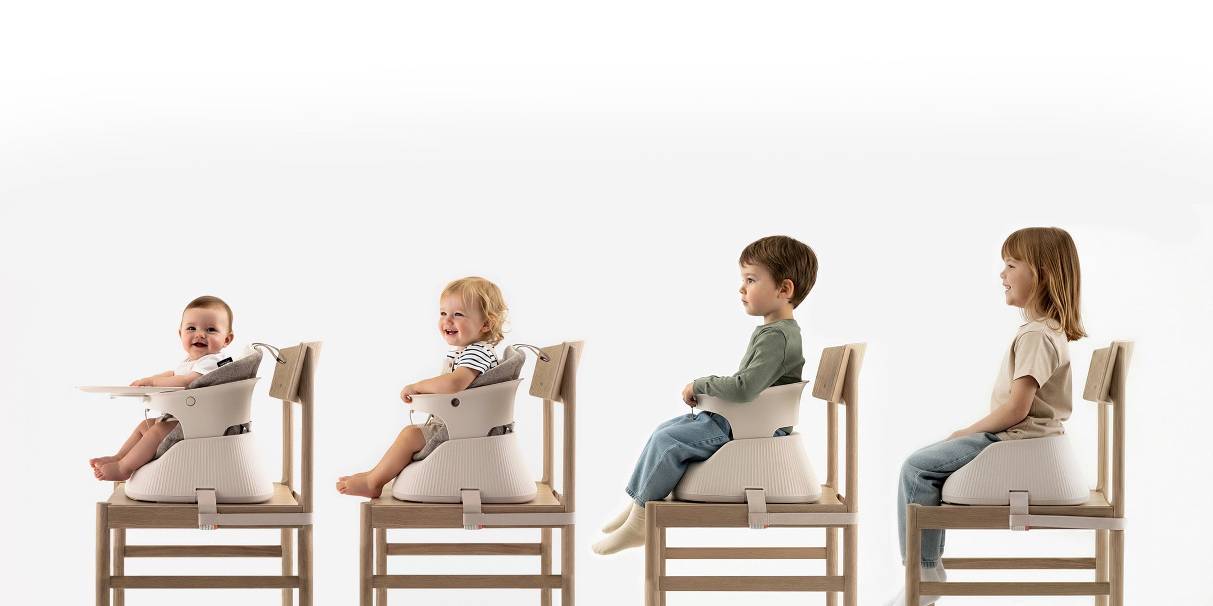 The same Hannie chair carrying a baby, a toddler, a preschooler and a five-year-old, four ages side by side