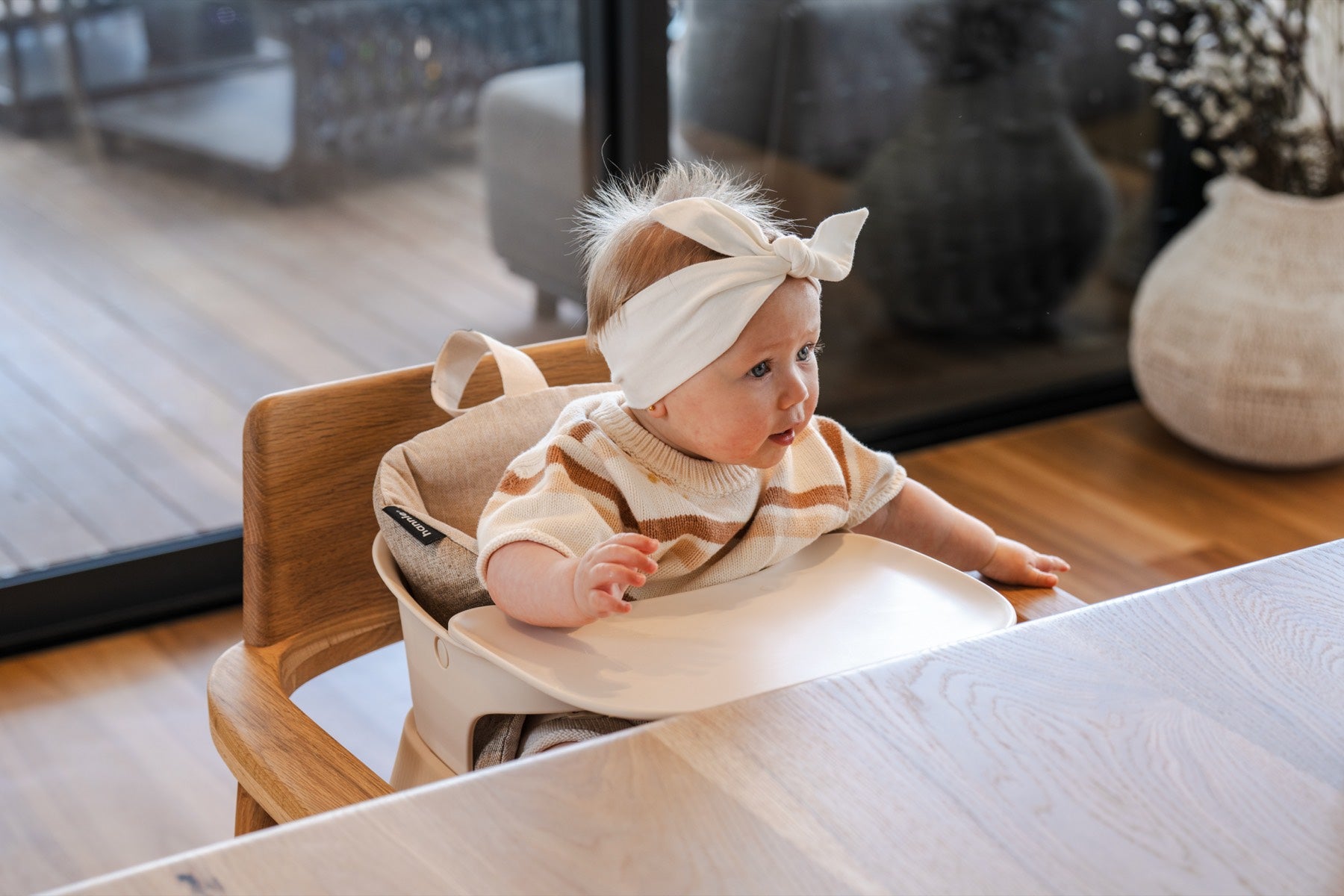 Baby at the family table in the Hannie Portable High Chair